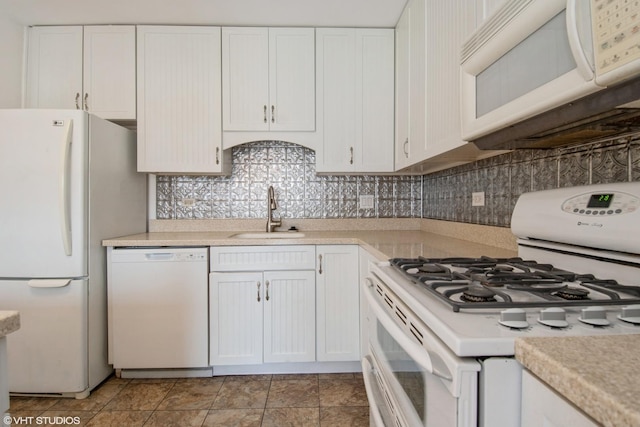 7010 Dover Ct Unit 203, Woodridge, IL 60517 - kitchen with white appliances, white cabinets, light countertops, a sink, and backsplash