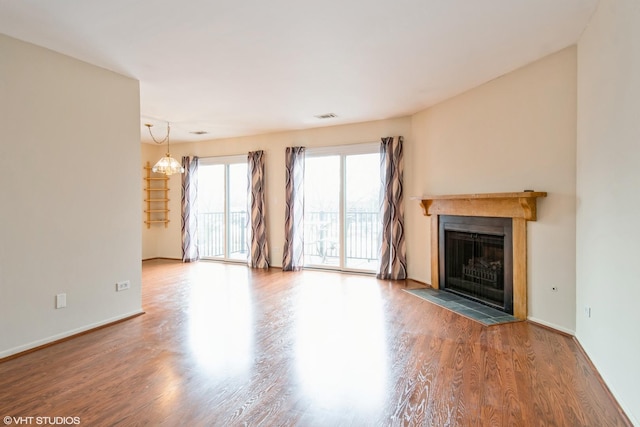 7010 Dover Ct Unit 203, Woodridge, IL 60517 - unfurnished living room with a fireplace with flush hearth, visible vents, a chandelier, wood finished floors, and baseboards