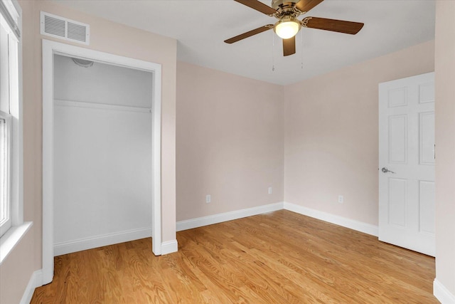unfurnished bedroom with baseboards, visible vents, and light wood-type flooring