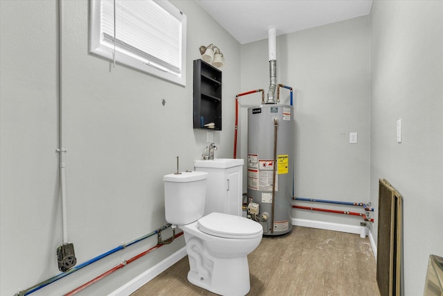 bathroom featuring toilet, wood finished floors, baseboards, and gas water heater