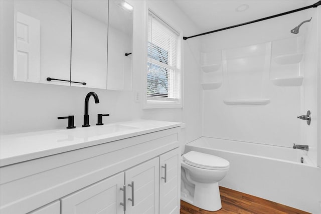 full bath featuring toilet, vanity, shower / washtub combination, and wood finished floors