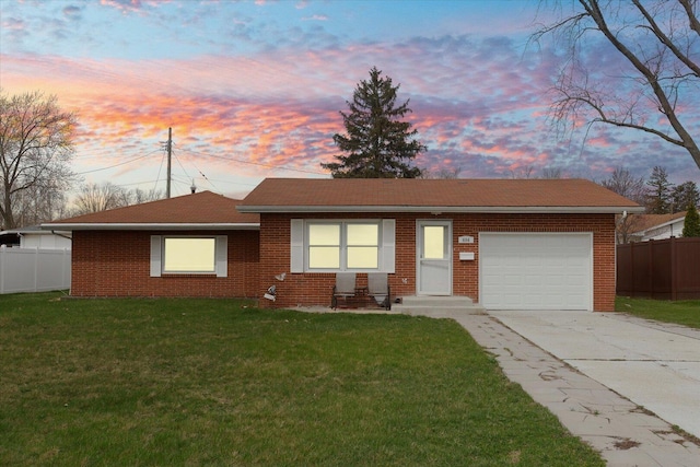 single story home featuring an attached garage, fence, concrete driveway, and a front yard