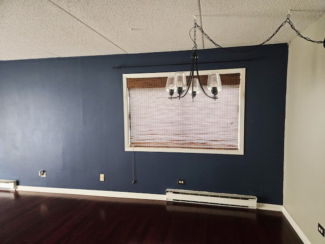 324 Klein Creek Ct Unit A, Carol Stream, IL 60188 - unfurnished dining area featuring baseboard heating, a textured ceiling, a chandelier, wood finished floors, and baseboards