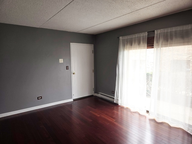 324 Klein Creek Ct Unit A, Carol Stream, IL 60188 - spare room with dark wood-style flooring, a baseboard heating unit, baseboards, and a textured ceiling