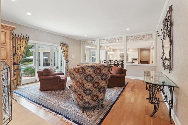 living room featuring baseboards, wood finished floors, and recessed lighting