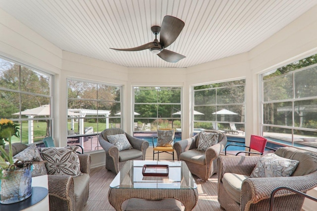 sunroom / solarium with an outdoor living space and ceiling fan