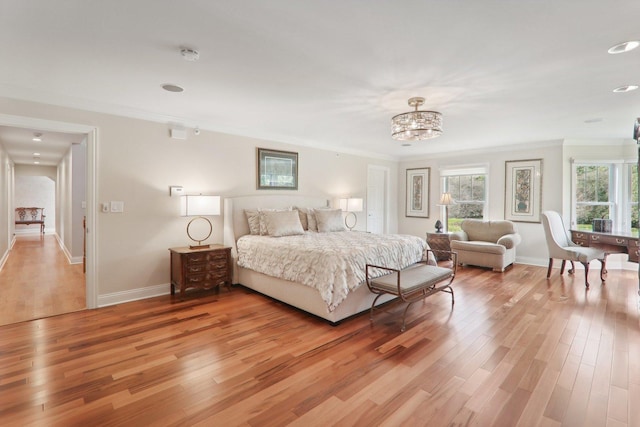 bedroom featuring light wood-style floors, a chandelier, multiple windows, and crown molding