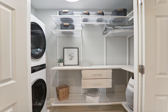 washroom featuring laundry area and stacked washing maching and dryer