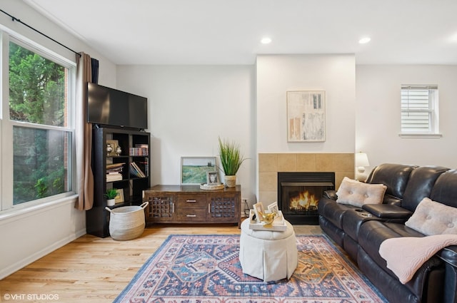 4134 S Ellis Ave, Chicago, IL 60653 - living room featuring wood finished floors, a tiled fireplace, recessed lighting, and baseboards