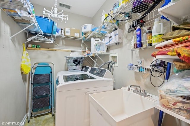 4134 S Ellis Ave, Chicago, IL 60653 - washroom featuring washing machine and dryer and a chandelier