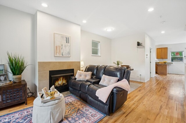 4134 S Ellis Ave, Chicago, IL 60653 - living room with a tiled fireplace, light wood-type flooring, recessed lighting, and baseboards