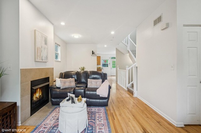 4134 S Ellis Ave, Chicago, IL 60653 - living room featuring stairs, a fireplace, light wood-type flooring, recessed lighting, and baseboards