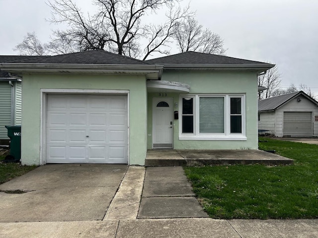 view of front of house featuring a shingled roof, driveway, stucco siding, and a garage