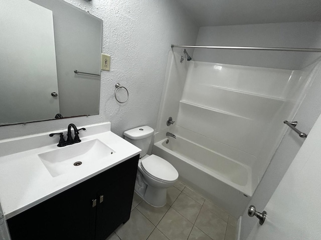 bathroom featuring tile patterned flooring, vanity, toilet, a textured wall, and washtub / shower combination