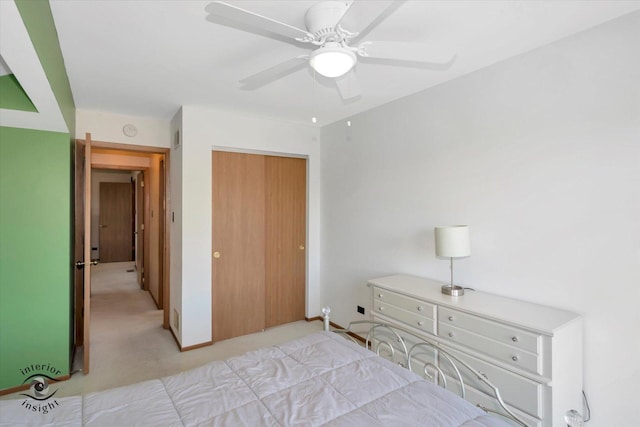 bedroom with a closet, light carpet, and ceiling fan