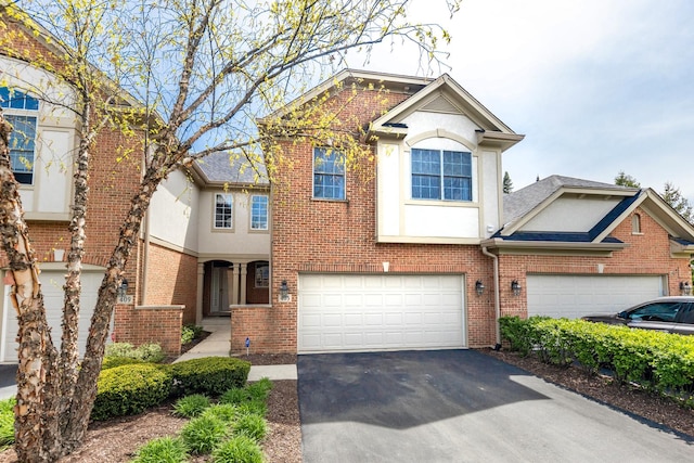 405 Ashbury Ln, Lemont, IL 60439 - view of front of home featuring driveway, stucco siding, brick siding, and a garage