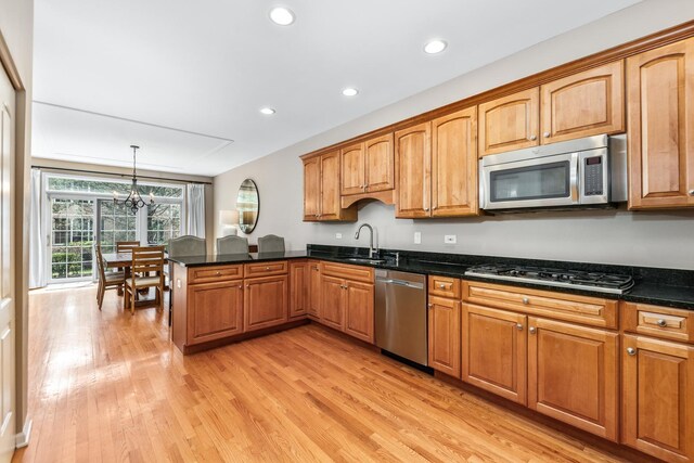 405 Ashbury Ln, Lemont, IL 60439 - kitchen with appliances with stainless steel finishes, light wood-style flooring, a peninsula, recessed lighting, and a chandelier