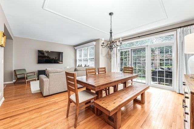 405 Ashbury Ln, Lemont, IL 60439 - dining room featuring a chandelier, light wood-style floors, and baseboards