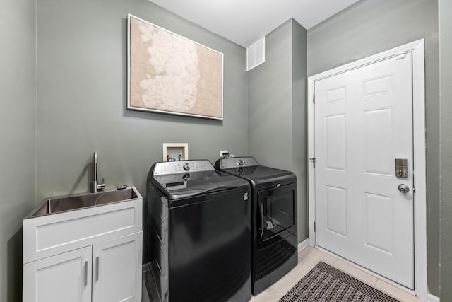 405 Ashbury Ln, Lemont, IL 60439 - washroom featuring washing machine and dryer, cabinet space, and light tile patterned floors