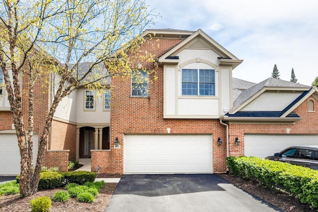 405 Ashbury Ln, Lemont, IL 60439 - view of front of home with stucco siding, driveway, brick siding, a garage, and a shingled roof