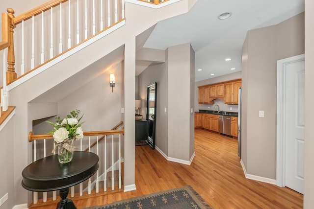 405 Ashbury Ln, Lemont, IL 60439 - corridor with light wood-style flooring, baseboards, a sink, recessed lighting, and an upstairs landing