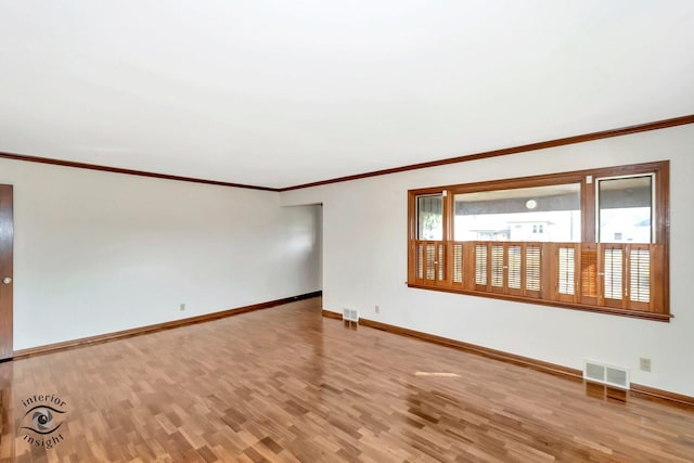 spare room with baseboards and visible vents