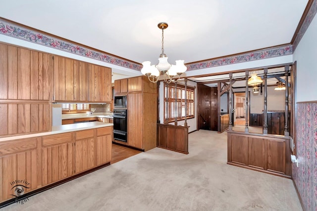 kitchen featuring a warming drawer, oven, built in microwave, light carpet, and a notable chandelier