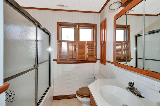 full bathroom with crown molding, wallpapered walls, toilet, vanity, and shower / bath combination with glass door