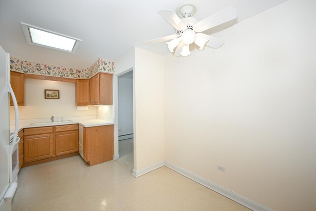 4248 Saratoga Ave Unit 308, Downers Grove, IL 60515 - kitchen with baseboards, a baseboard heating unit, light countertops, freestanding refrigerator, and a sink