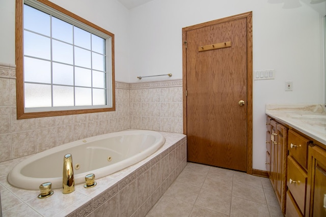 bathroom featuring tile patterned floors, a whirlpool tub, and vanity