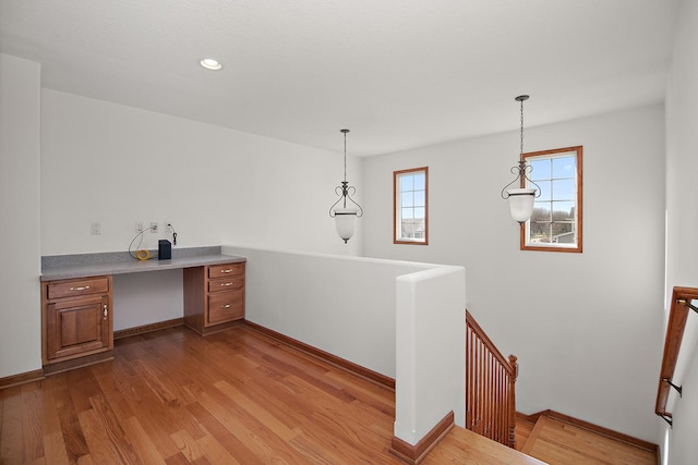 unfurnished office featuring baseboards, wood finished floors, and recessed lighting