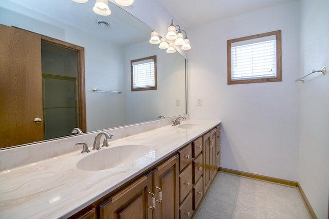full bathroom featuring baseboards, double vanity, a sink, and a shower with door