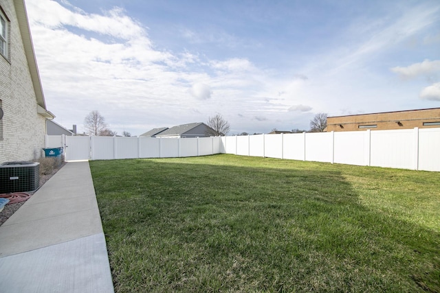 view of yard featuring a fenced backyard and central air condition unit