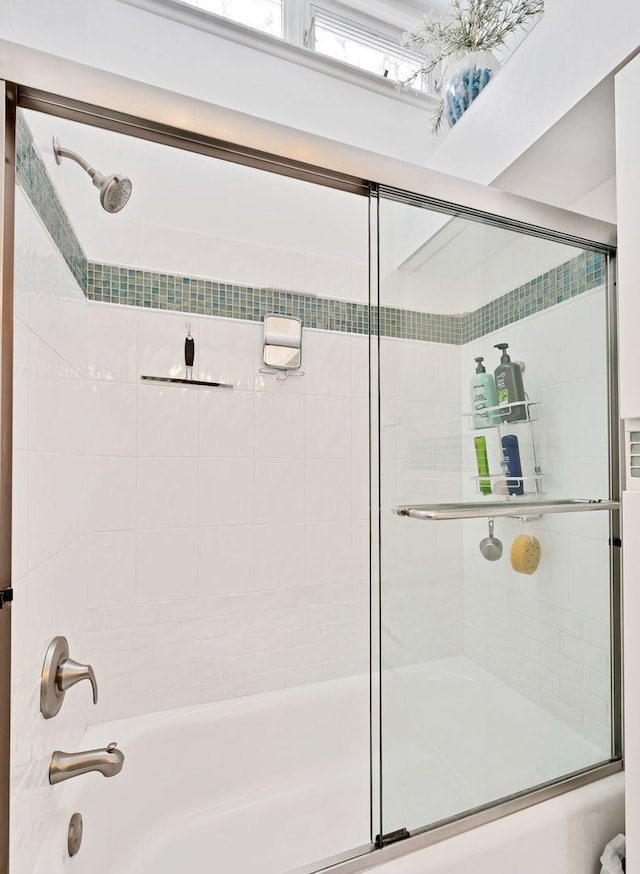 full bath featuring shower / bath combination with glass door