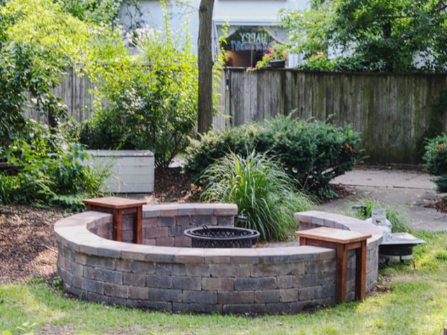 view of yard with fence and a fire pit