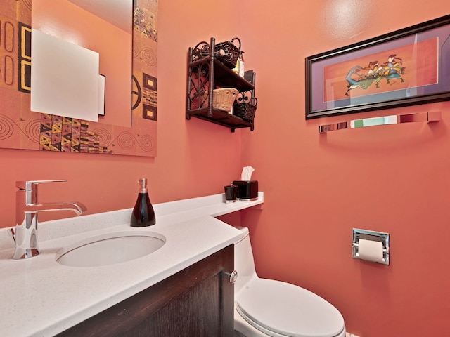 bathroom featuring toilet and vanity