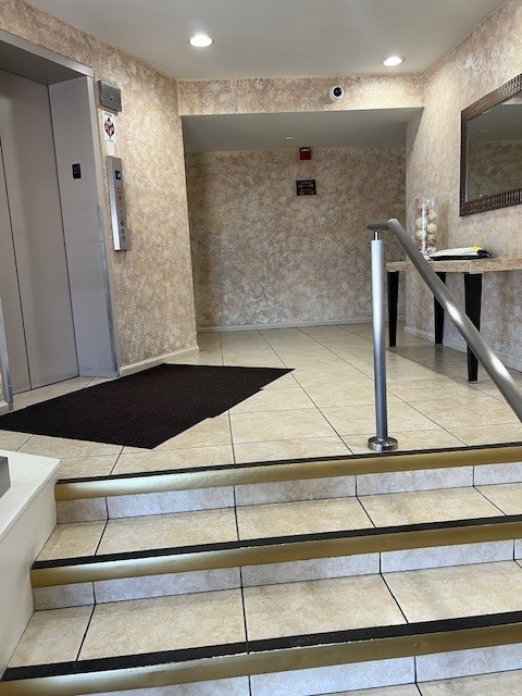 4901 Golf Rd Unit 405, Skokie, IL 60077 - stairs with elevator, tile patterned floors, and recessed lighting