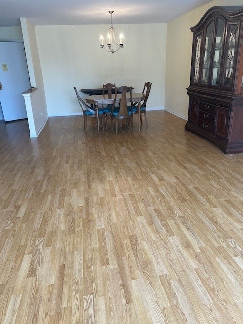 4901 Golf Rd Unit 405, Skokie, IL 60077 - dining space featuring light wood finished floors, a notable chandelier, and baseboards