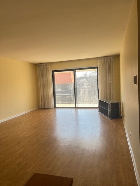 4901 Golf Rd Unit 405, Skokie, IL 60077 - empty room featuring baseboards and wood finished floors