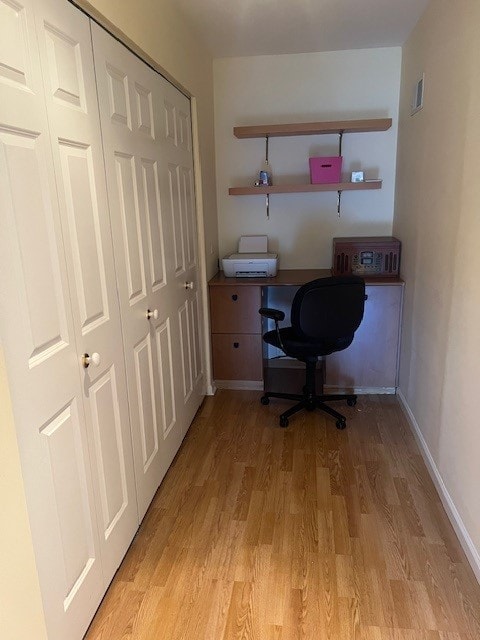 4901 Golf Rd Unit 405, Skokie, IL 60077 - home office with built in desk, baseboards, and light wood-type flooring