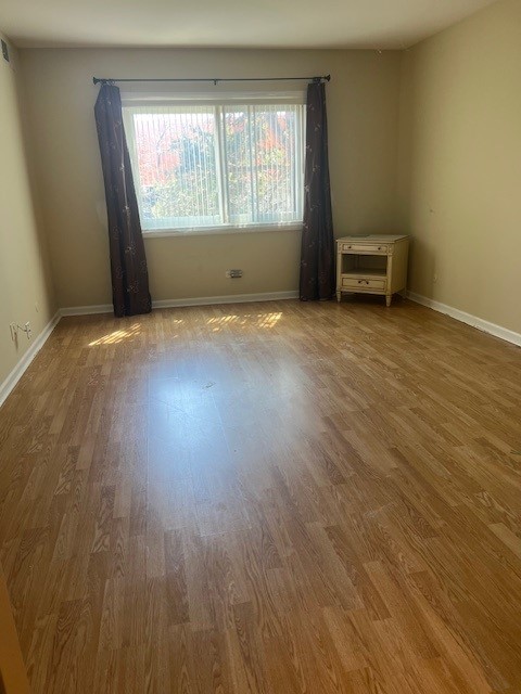 4901 Golf Rd Unit 405, Skokie, IL 60077 - empty room featuring baseboards and wood finished floors