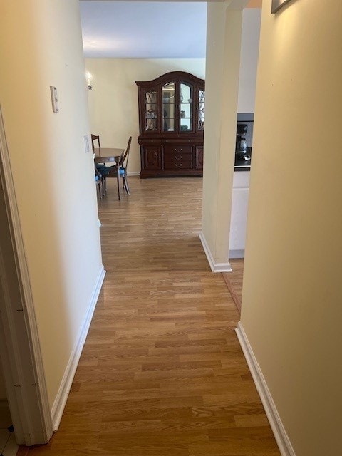 4901 Golf Rd Unit 405, Skokie, IL 60077 - hallway featuring baseboards and light wood-type flooring