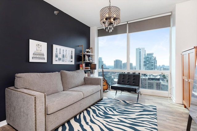 living area featuring expansive windows, a view of city, wood finished floors, and a chandelier