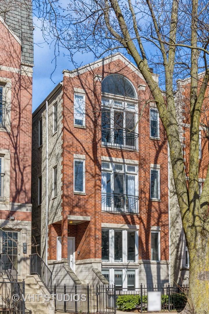 3312 N Damen Ave Unit 2, Chicago, IL 60618 - view of property featuring brick siding and a fenced front yard