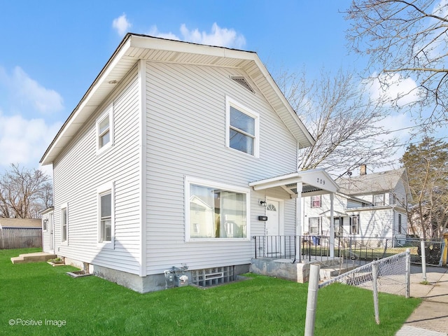 view of front of home with a front yard and fence