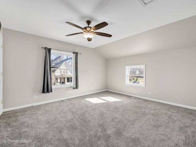 spare room with lofted ceiling, carpet flooring, baseboards, and ceiling fan