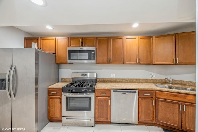 4337 S Prairie Ave Unit G, Chicago, IL 60653 - kitchen featuring recessed lighting, stainless steel appliances, a sink, light stone countertops, and brown cabinets