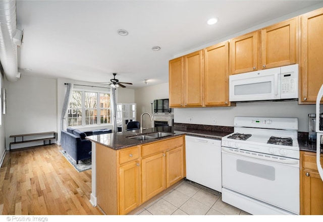 kitchen featuring a peninsula, a sink, ceiling fan, white appliances, and recessed lighting