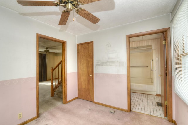 3902 Rose Ave, Western Springs, IL 60558 - unfurnished bedroom featuring light colored carpet, ensuite bath, a textured ceiling, and a ceiling fan