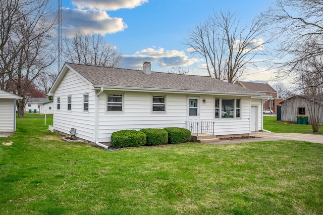 view of front of home with a front lawn, a shingled roof, and a chimney